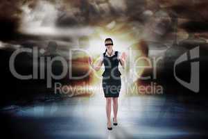 Composite image of redhead businesswoman in a blindfold