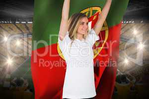 Pretty football fan in white cheering holding portugal flag