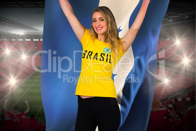 Excited football fan in brasil tshirt holding honduras flag