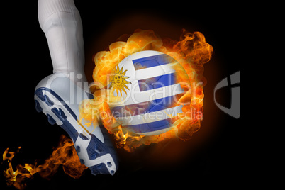 Football player kicking flaming uruguay ball