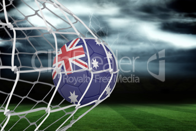 Football in australia colours at back of net