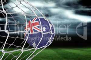 Football in australia colours at back of net