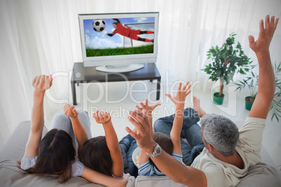 Family cheering and watching the world cup at home