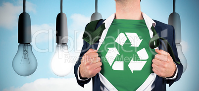 Composite image of businessman opening shirt in superhero style