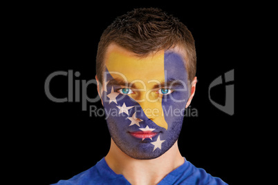 Serious young bosnian fan with facepaint