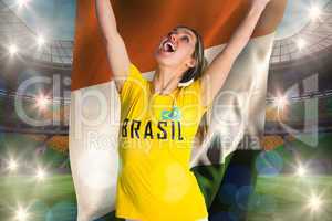 Pretty football fan in brasil t-shirt holding ivory coast flag