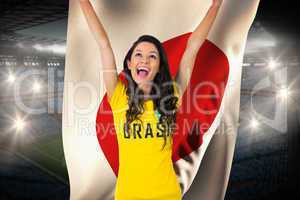 Excited football fan in brasil tshirt holding japan flag