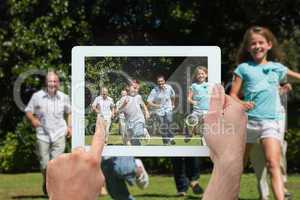 Composite image of hand holding tablet pc