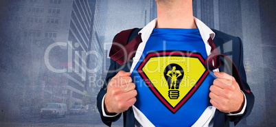 Composite image of businessman opening shirt in superhero style