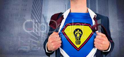 Composite image of businessman opening shirt in superhero style