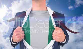 Businessman opening shirt to reveal nigeria flag