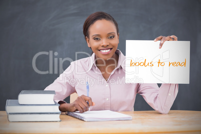 Happy teacher holding page showing books to read