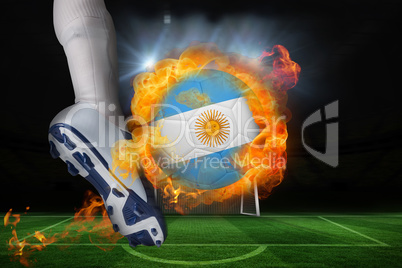 Football player kicking flaming argentina flag ball