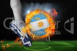 Football player kicking flaming argentina flag ball