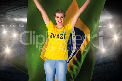 Excited football fan in brasil tshirt holding brasil flag