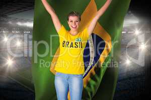 Excited football fan in brasil tshirt holding brasil flag