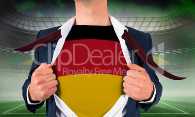 Businessman opening shirt to reveal germany flag