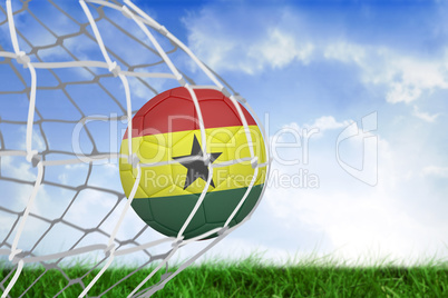 Football in ghana colours at back of net