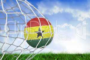 Football in ghana colours at back of net