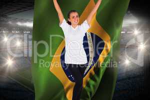 Excited football fan in white cheering holding brasil flag