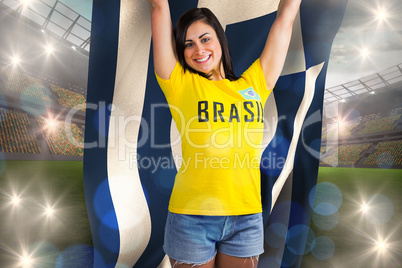 Excited football fan in brasil tshirt holding greece flag