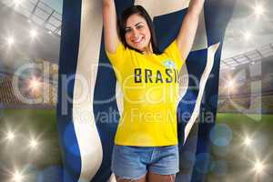 Excited football fan in brasil tshirt holding greece flag