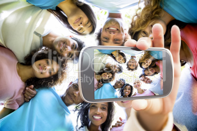 Composite image of hand holding smartphone showing