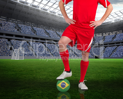 Football player standing with brasil ball