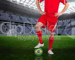 Football player standing with brasil ball