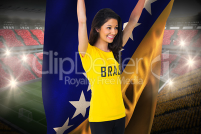 Excited football fan in brasil tshirt holding bosnia flag