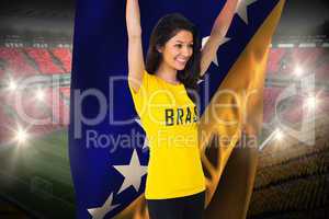 Excited football fan in brasil tshirt holding bosnia flag