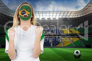 Excited brasil fan in face paint cheering