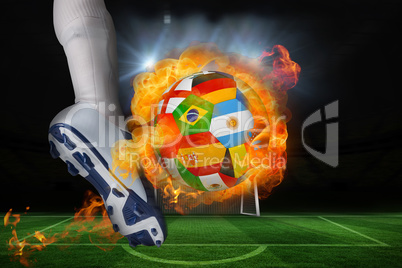 Football player kicking flaming international flag ball