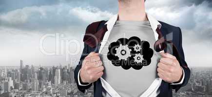 Composite image of businessman opening shirt in superhero style