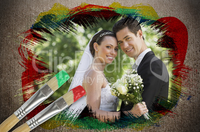 Composite image of newlyweds smiling at camera