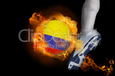Football player kicking flaming colombia ball