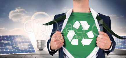 Composite image of businessman opening shirt in superhero style