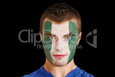 Serious young nigeria fan with facepaint