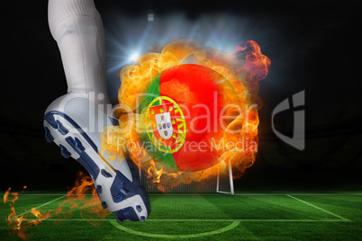 Football player kicking flaming portugal flag ball
