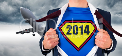 Composite image of businessman opening shirt in superhero style