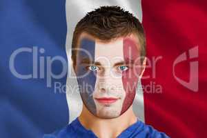 Serious young france fan with facepaint
