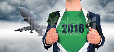 Composite image of businessman opening shirt in superhero style