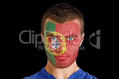 Serious young portugal fan with facepaint