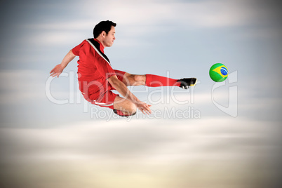 Football player in red kicking