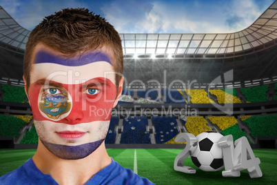 Serious young costa rica fan with face paint