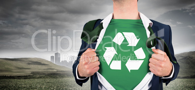 Composite image of businessman opening shirt in superhero style