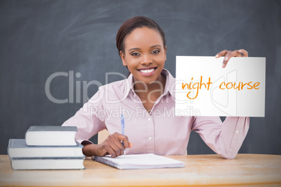 Happy teacher holding page showing night course