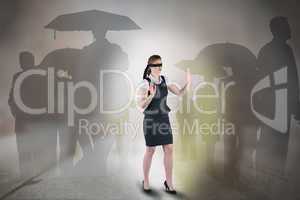 Composite image of redhead businesswoman in a blindfold