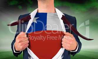 Businessman opening shirt to reveal chile flag