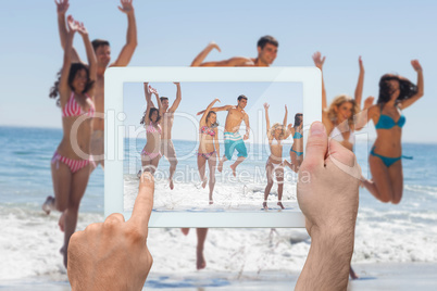 Composite image of hand holding tablet pc Composite image of hand holding tablet pc